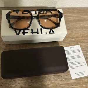 Like-new Vehla sunglasses in tortoise shell design and copper tinted lenses